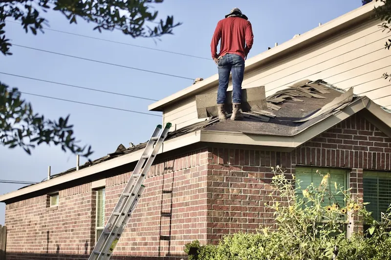 Professional roofer working on a residential roof in Markle